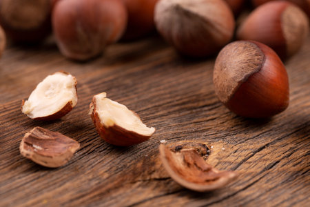 Hazelnuts in on rustic background. Pile of hazelnuts.