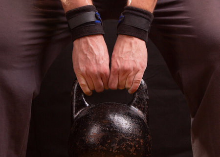 Sports kettlebell in the hand of the athlete.の写真素材