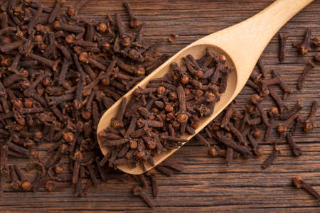 Clove seeds close-up. Dried clove seeds in a wooden spoon.の写真素材