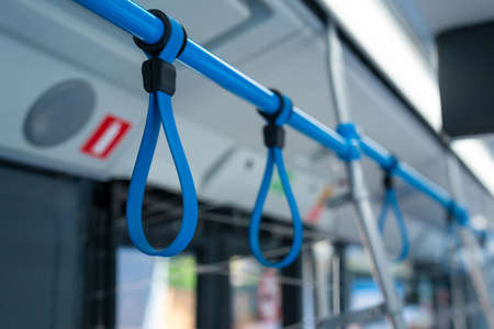 Handles for standing passenger inside a bus. Bus hangers for people that are standing to hold on something during ride.の写真素材