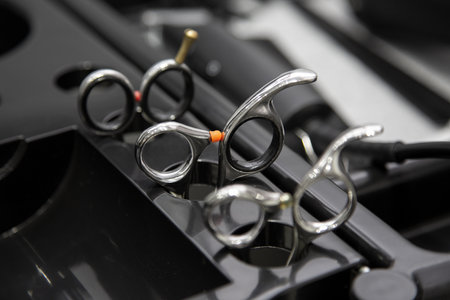 Set of hairdresser scissors close-up. Barber tool in a trolley.
