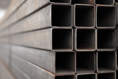 Square profile pipe close-up. Metal profile pipe of rectangular cross section in packs at the warehouse of metal products.の写真素材