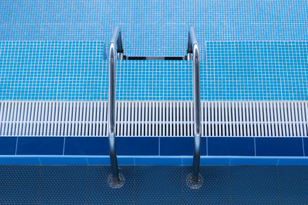 Empty swimming pool with descent down. Staircase leading to the pool.
