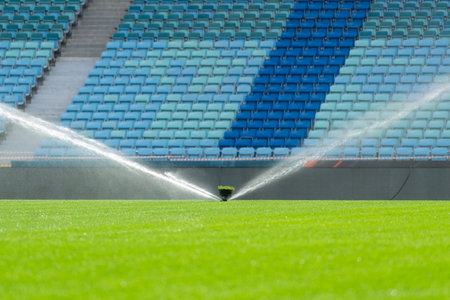 Football turf irrigation system close-up. Watering the grass on the football field.の写真素材