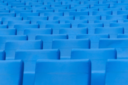Empty seats in the stands of the arena or auditorium. Rows of blue seats without spectators.の写真素材