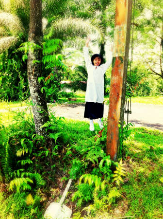 Happy girl in school uniform jumpingの素材