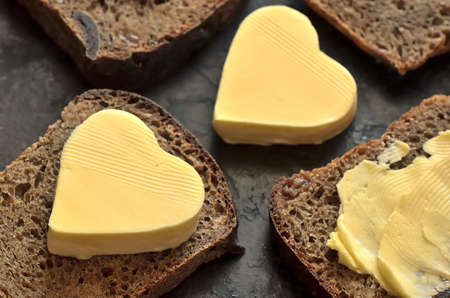 Bread with a heart shaped butter on itの写真素材