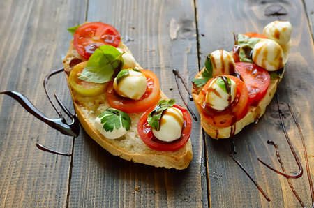 Bruschetta with mozzarella and herbs seasoned with balsamic vinegarの写真素材