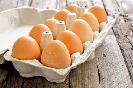 Fresh organic eggs on a wooden background