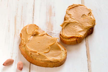 Peanut butter sandwiches or toasts  on light wooden backgroundの写真素材
