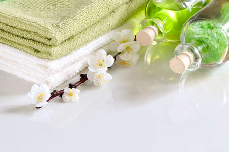 Refreshing spring spa set with scented sea salt and essential oil for massage or aroma theraphy decorated with apricot flowersの写真素材