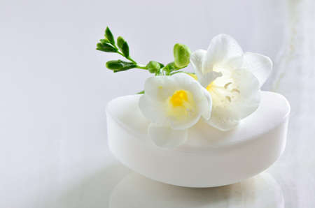 Organic natural soap decorated with white flowerの写真素材