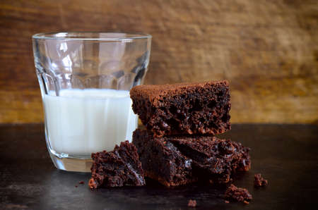 Homemade chocolate brownies with glass of milkの写真素材