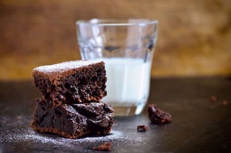 Homemade chocolate brownies with glass of milkの写真素材