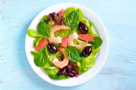 Diet shrimp and fresh greens salad with juicy slices of grapefruit, top viewの写真素材