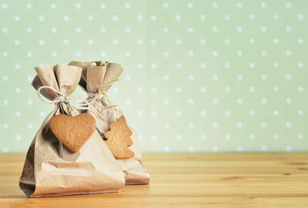 Handmade presents decorated with  Christmas gingerbreads, retro stylized imageの写真素材