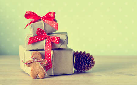 Simply wrapped christmas gifts decorated with red polka dot bows, vintage stylized photoの写真素材
