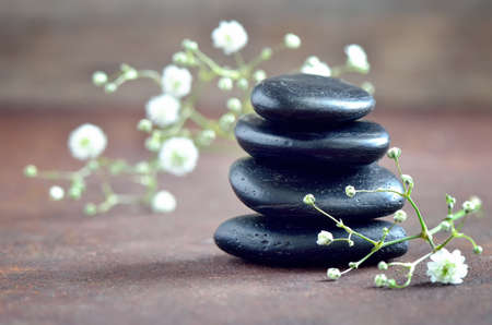 Stack of zen stones decorated with flowers, spa spring conceptの写真素材