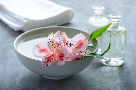 Aromatherapy spa concept, bowl with aromatic water decorated withflowersの写真素材