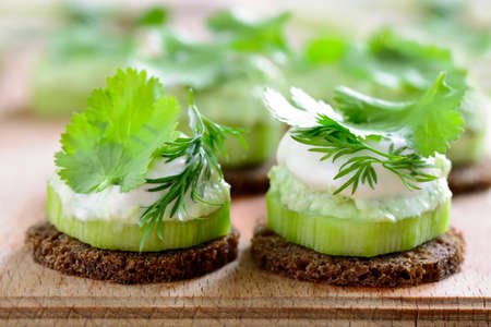 Cucumber and whipped with spring herbs feta cheese mini snacks seasoned with cilantro and dillの写真素材