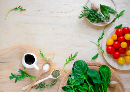 Tomato and greens salad ingredients, culinary back ground, top viewの写真素材