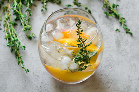 Peaches and thyme cocktail or lemonade or infused waterの写真素材