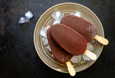 Chocolate ice cream pops on a hip of ice , view from aboveの写真素材