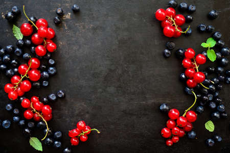 Summer background, summer berries on a dark surface, top view, space for a textの写真素材