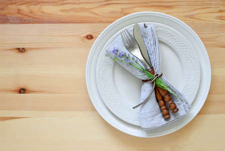 Rustic simple summer season table setting decorated with lavender flower, top view