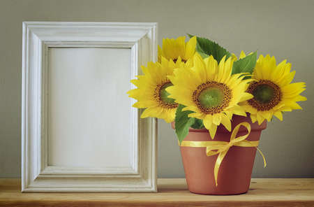 Autum greeting card with space in a frame for a text, setting with sunflowers bouquet, retro...