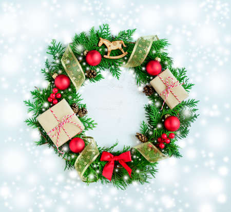 Christmas wreath in a snow, stylized photoの写真素材