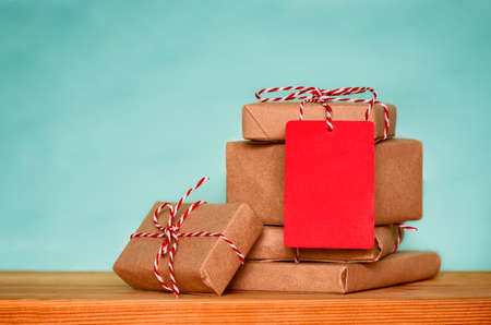 Christmas sale concept, stack of christmas presents with red tag with empty space for a textの写真素材