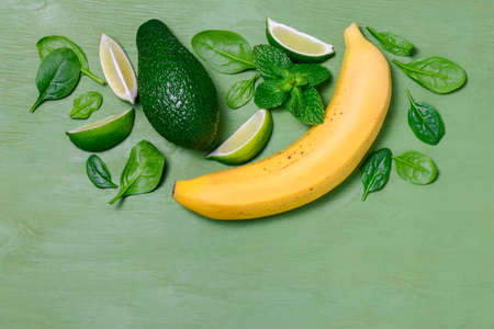 Avocado and banana spinach smoothies concept, top view, flat lay, space for a textの写真素材