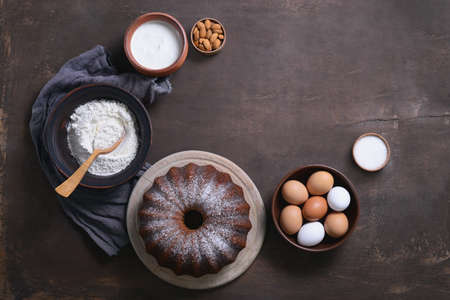 Bundt cake ingredients, moody bakery background with aspace for a text, top viewの写真素材