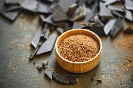 Cocoa powder in a wooden bowl, chocolate ingredient conceptの写真素材
