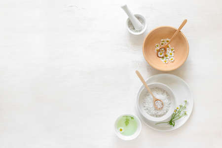 Spa background with various natural cosmetic components and chamomile flowers, view from aboveの写真素材