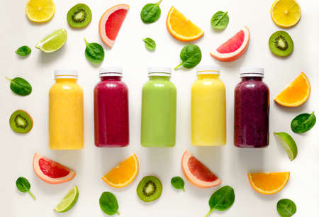 Various kind of smoothies or juices in bottles, healthy diet food concept, view from aboveの写真素材