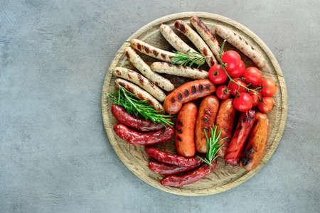 Various kind of grilled sausages on a board, view from aboveの写真素材