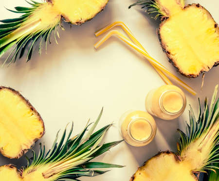 Pineapple smoothies or juice background, view from above, space for a text