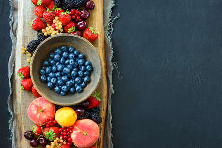 Various summer garden berries background with a space for a text, view from above, flat layの写真素材