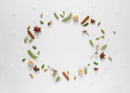 Christmas tree twigs, cardamom seeds and anise stars, some small weathered fallen leaves and...