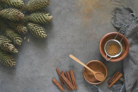 Christmas hollidays baking at home concept, broun sugar and cinnamon in bowls, view from above, space for a textの写真素材
