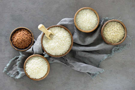 Different kinds of rice in ceramic bowls, overhead viewの写真素材