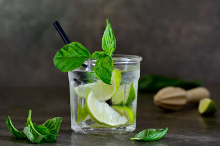 Basil limeade or alcohol cocktail in a glass, front viewの写真素材