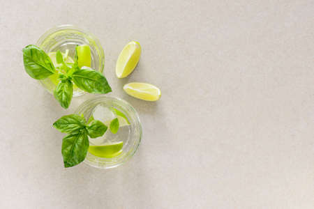 Basil and ginger limeade in two glasses, overhead view minimal composition with a space fpr a textの写真素材