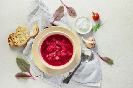 Vegetarian hot diet beetroot and tomato soup seasoned with garlic and served with light greek yogurt, overhead viewの写真素材