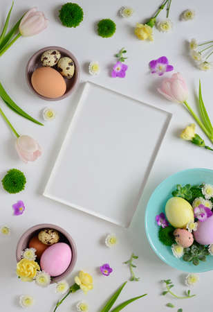 Easter greeting card or invitation leaflet tempate with a space for a text, flat lay arrangement, view from aboveの写真素材