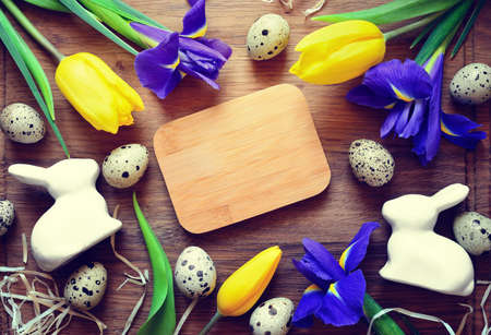 Easter background with traditional decorations and spring flowers on wooden background, view from above, space for a textの写真素材