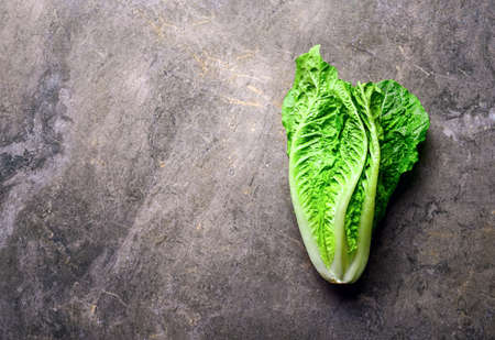 Lettuce on a kitchen stone table, view from above, space for a textの写真素材