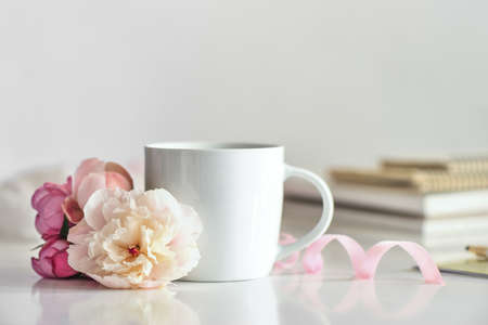 Coffee brake concept, white cup of coffee or tea on working desk, front viewの写真素材